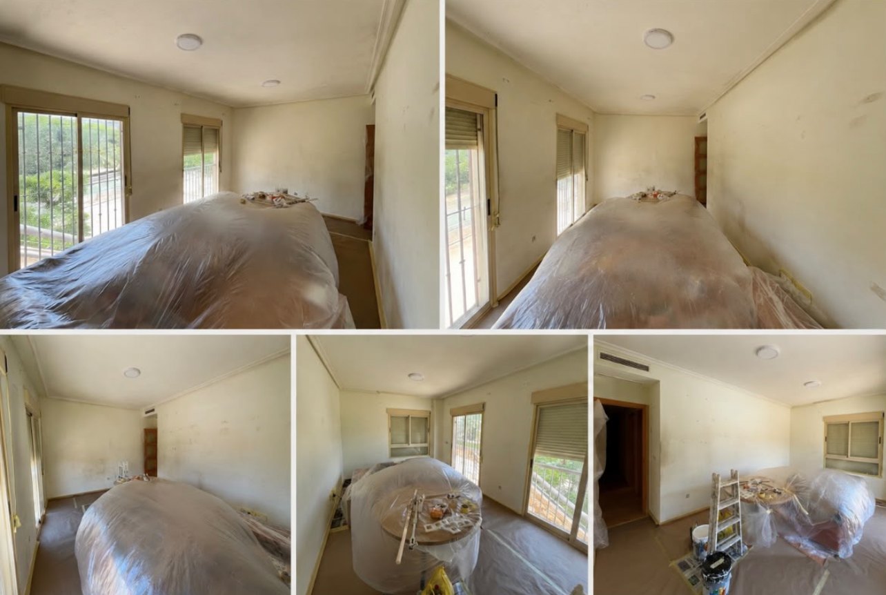 Room before painting: marked walls and covered furniture